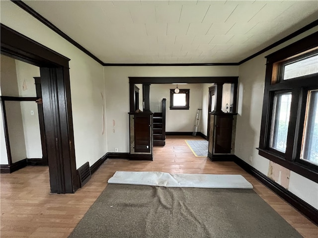 foyer featuring crown molding and wood-type flooring