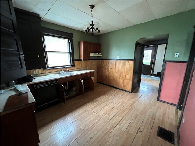 kitchen with light hardwood / wood-style flooring, a notable chandelier, dishwasher, and hanging light fixtures