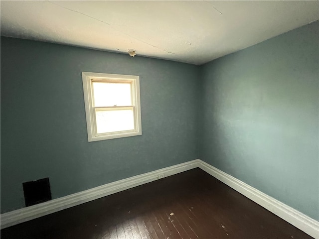 unfurnished room with hardwood / wood-style floors