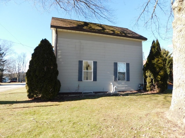 view of side of home with a lawn