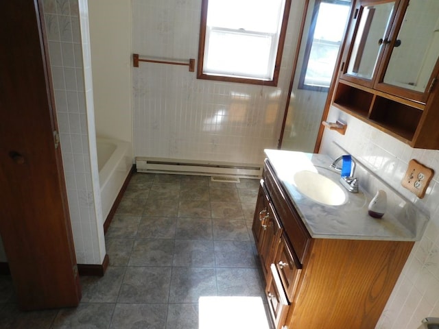 bathroom with tiled shower / bath combo, oversized vanity, backsplash, a baseboard heating unit, and tile floors