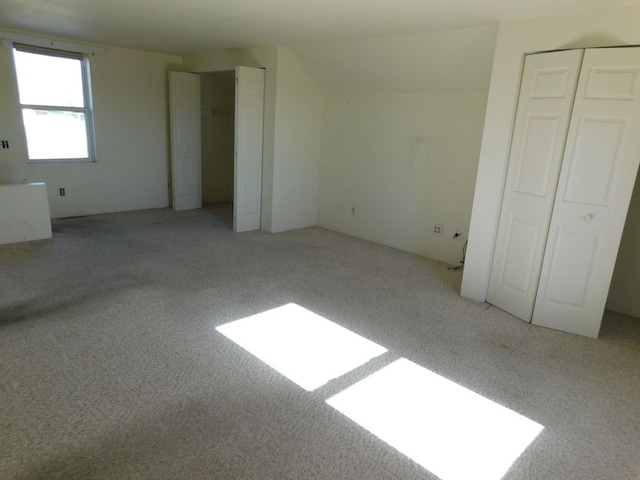 unfurnished bedroom with light colored carpet