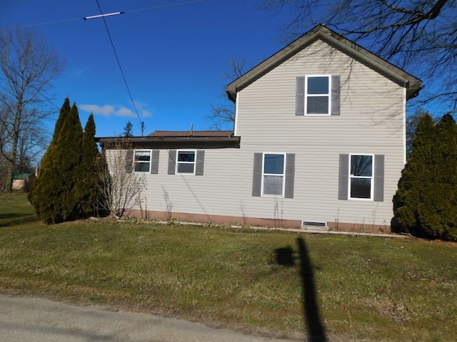 view of home's exterior with a yard