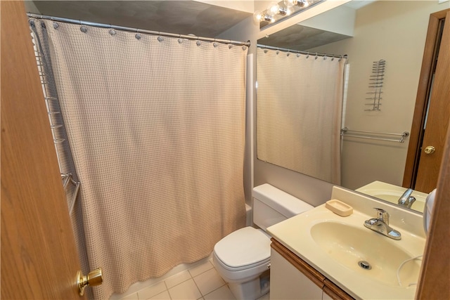 bathroom featuring tile patterned floors, vanity, and toilet