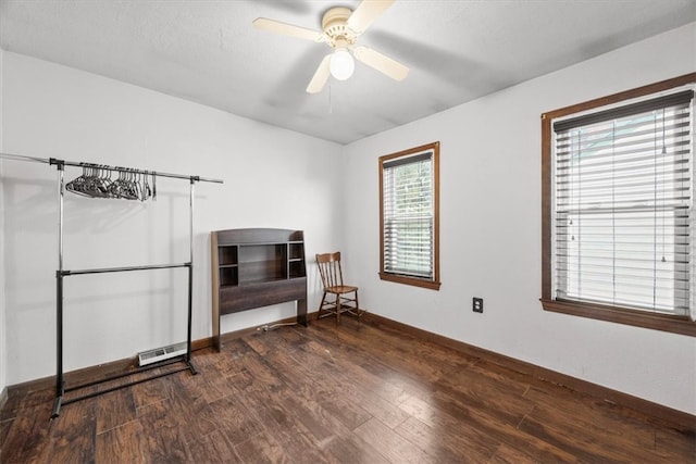 empty room featuring ceiling fan and dark hardwood / wood-style floors