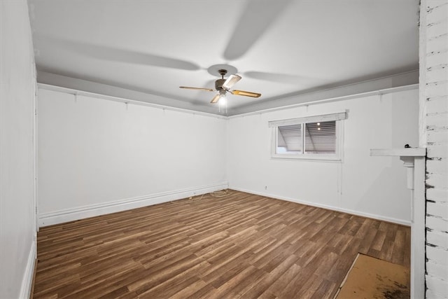 unfurnished room with dark hardwood / wood-style floors and ceiling fan