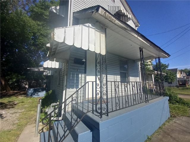 view of side of property featuring a porch