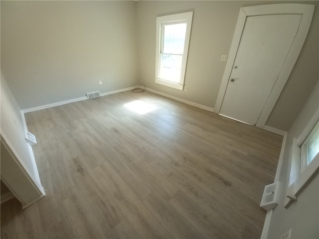 spare room featuring light wood-type flooring