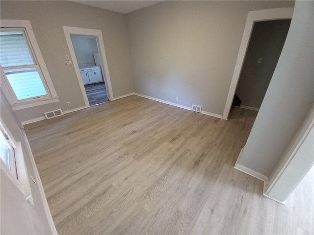 unfurnished room with light wood-type flooring