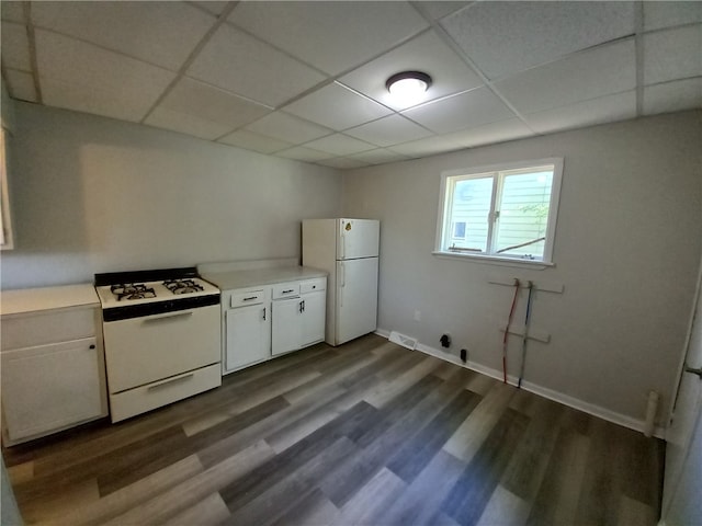 kitchen featuring white cabinetry, wood-type flooring, a paneled ceiling, and white appliances