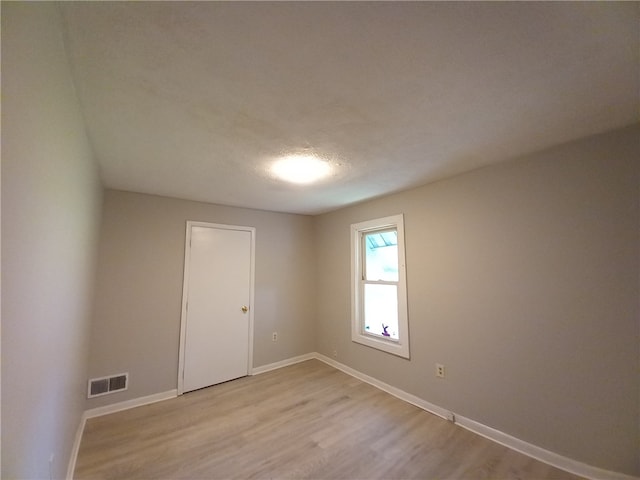 spare room with light wood-type flooring