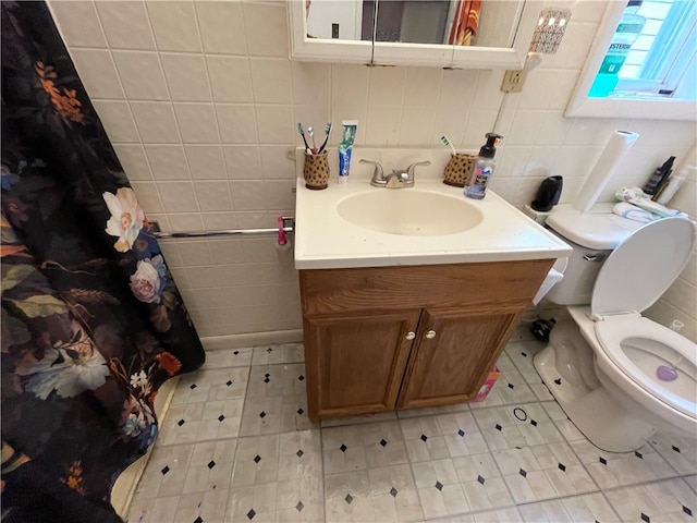 bathroom with vanity, toilet, tile walls, and decorative backsplash