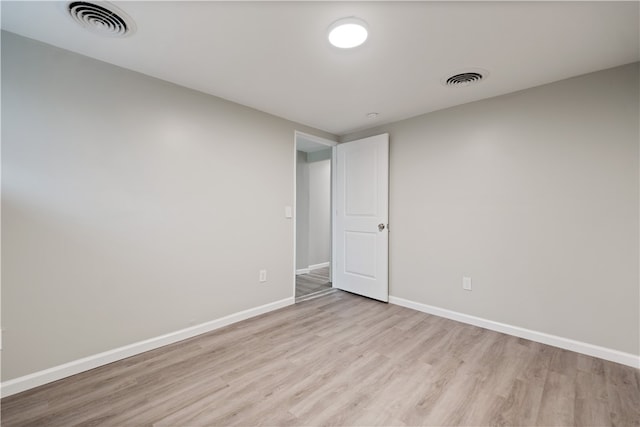 spare room featuring light wood-type flooring