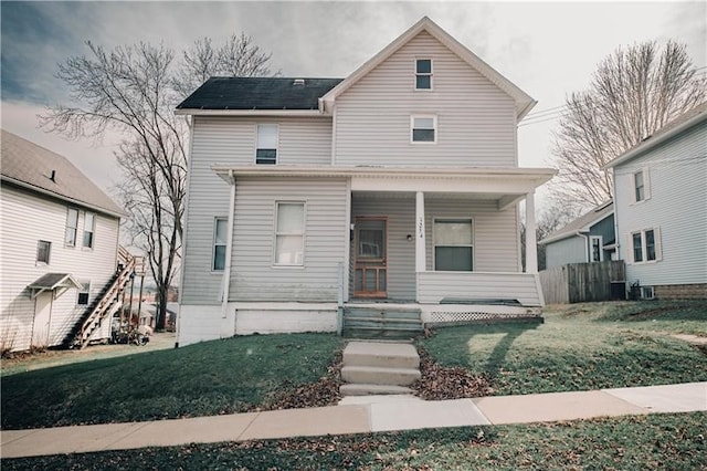 view of front of home featuring covered porch and a front yard