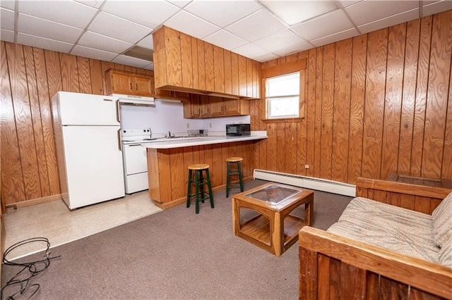 kitchen featuring a baseboard radiator, white appliances, a drop ceiling, and light carpet