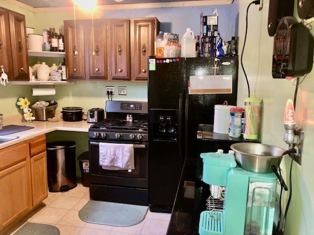 kitchen featuring black appliances and light tile flooring