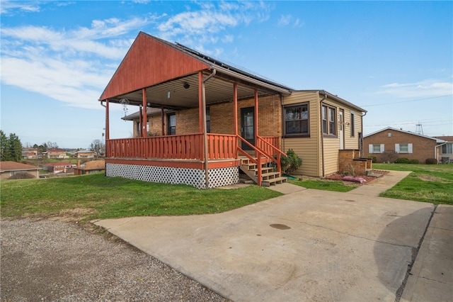 view of front of home featuring covered porch and a front yard