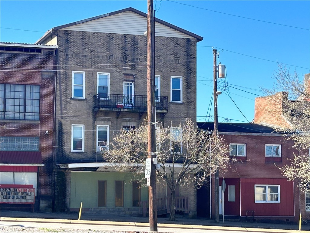 rear view of property featuring a balcony