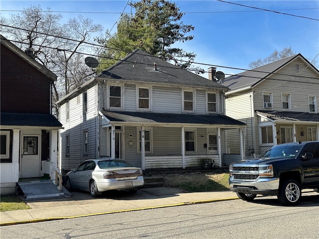 american foursquare style home featuring covered porch