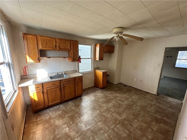 kitchen featuring tile floors, ceiling fan, and sink