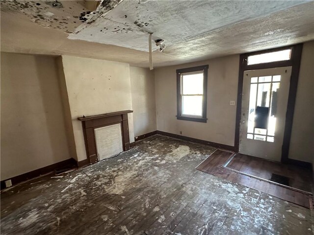 interior space featuring dark wood-type flooring and a textured ceiling