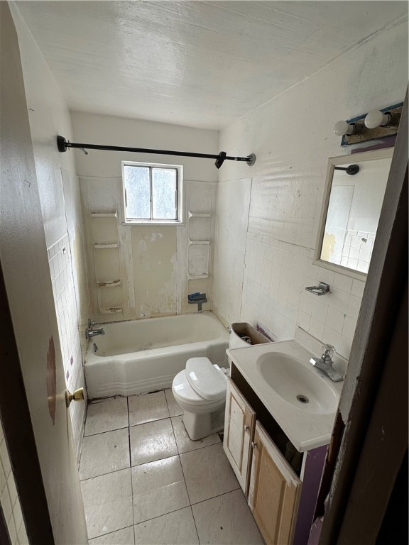 full bathroom with toilet, vanity, tiled shower / bath, tile walls, and tile floors