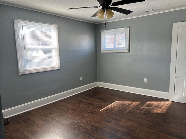 unfurnished room with ceiling fan, dark hardwood / wood-style flooring, and crown molding