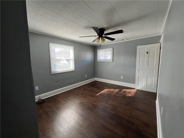 spare room with hardwood / wood-style flooring, crown molding, and ceiling fan