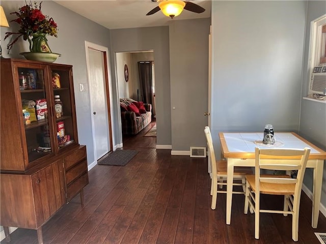 dining room featuring ceiling fan and dark wood-type flooring