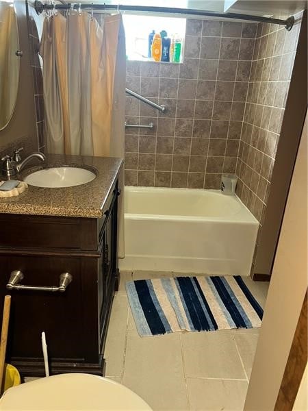 full bathroom with tile flooring, vanity, toilet, and shower / bath combo with shower curtain