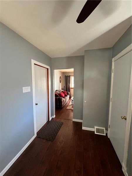 corridor with dark hardwood / wood-style floors