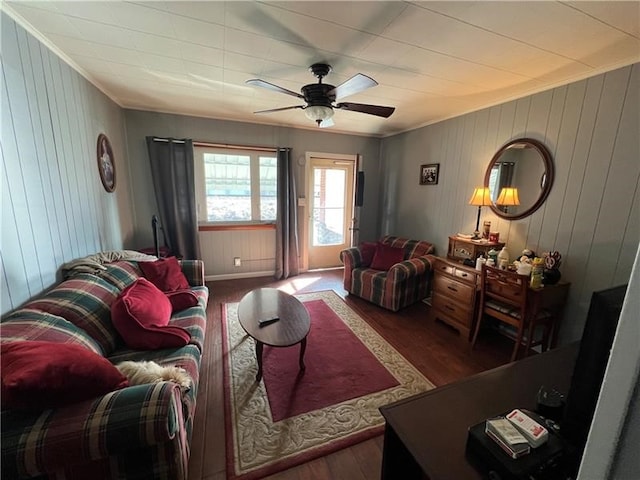 living room with ceiling fan, crown molding, and dark wood-type flooring