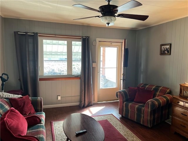 living room with ceiling fan and dark hardwood / wood-style floors