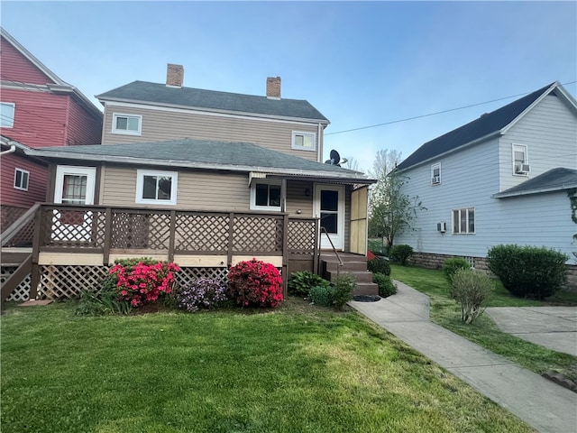 rear view of house with a yard