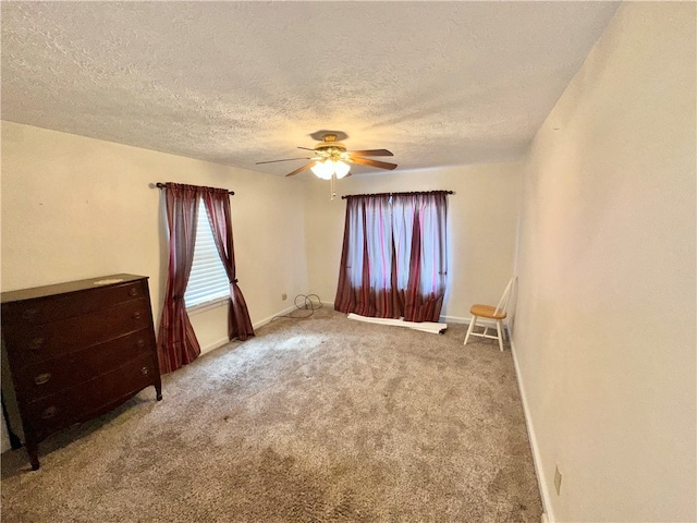 unfurnished room with ceiling fan, light carpet, and a textured ceiling