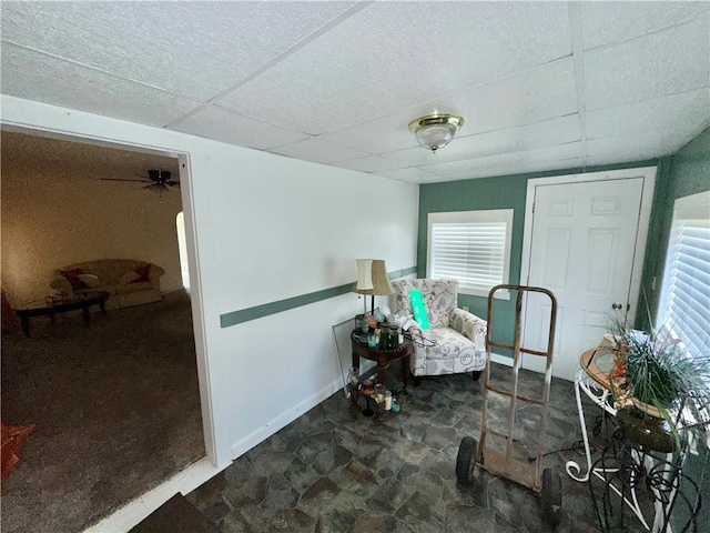 sitting room featuring a paneled ceiling and ceiling fan