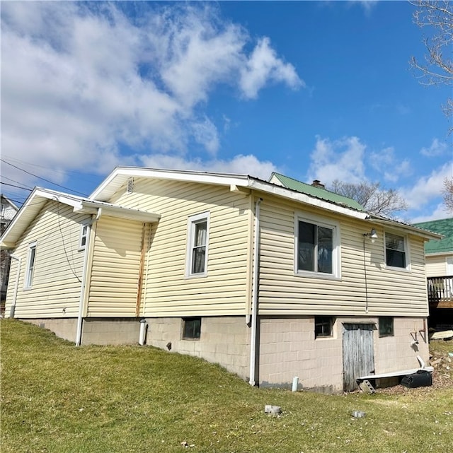 view of side of home with a yard