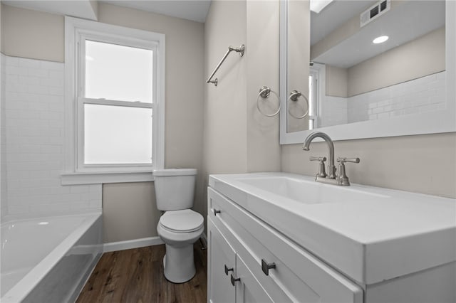 full bathroom with toilet, vanity, hardwood / wood-style flooring, and shower / tub combination