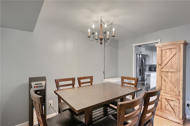 dining space with an inviting chandelier