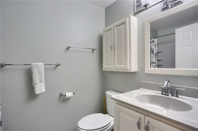 bathroom featuring toilet and vanity with extensive cabinet space