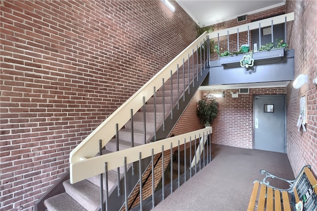 stairs featuring brick wall