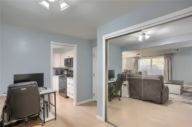 office area with light hardwood / wood-style floors