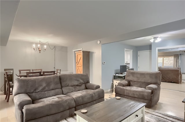 living room with light wood-type flooring and a chandelier