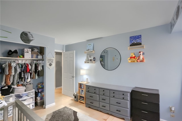 bedroom featuring a closet and light wood-type flooring