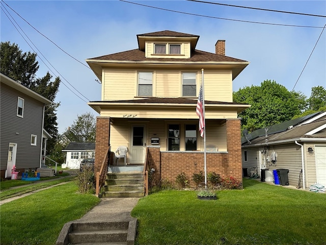 view of front of property featuring covered porch and a front yard