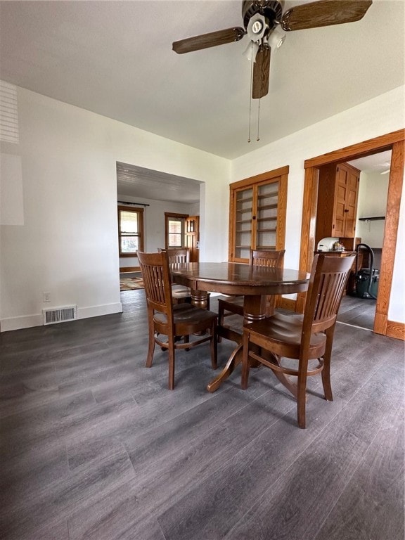 dining area featuring ceiling fan and dark hardwood / wood-style floors