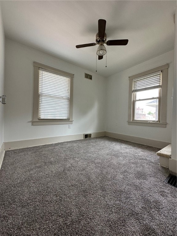 carpeted empty room featuring ceiling fan