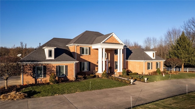 greek revival inspired property with a front lawn