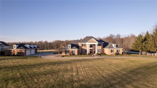 view of front of house featuring a front lawn and a garage