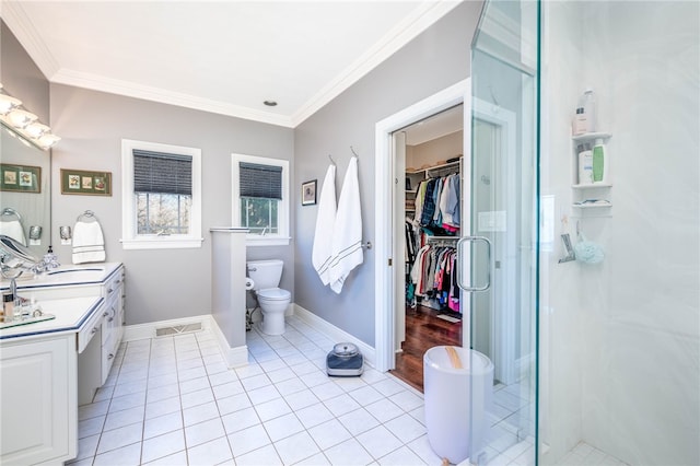 bathroom featuring walk in shower, dual vanity, tile floors, toilet, and crown molding